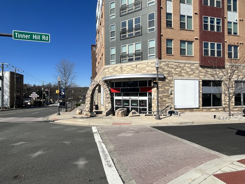 Picture of Tinner Hill Monument Arch in front of large apartment complex