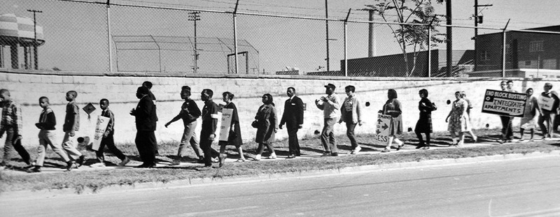 Photograph of Marching ACCESS Members along a road in Fairfax in 1966.