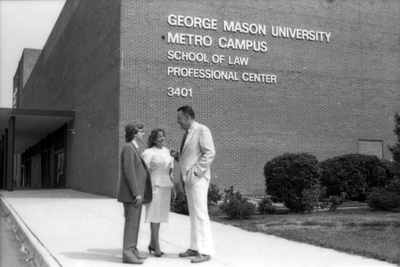 Photograph of John "Til" Hazel and students in front of a George Mason University building in 1982.