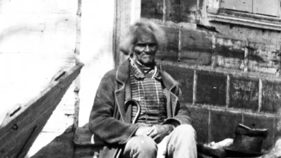 Photograph of West Ford sitting outside a building, circa 1860.