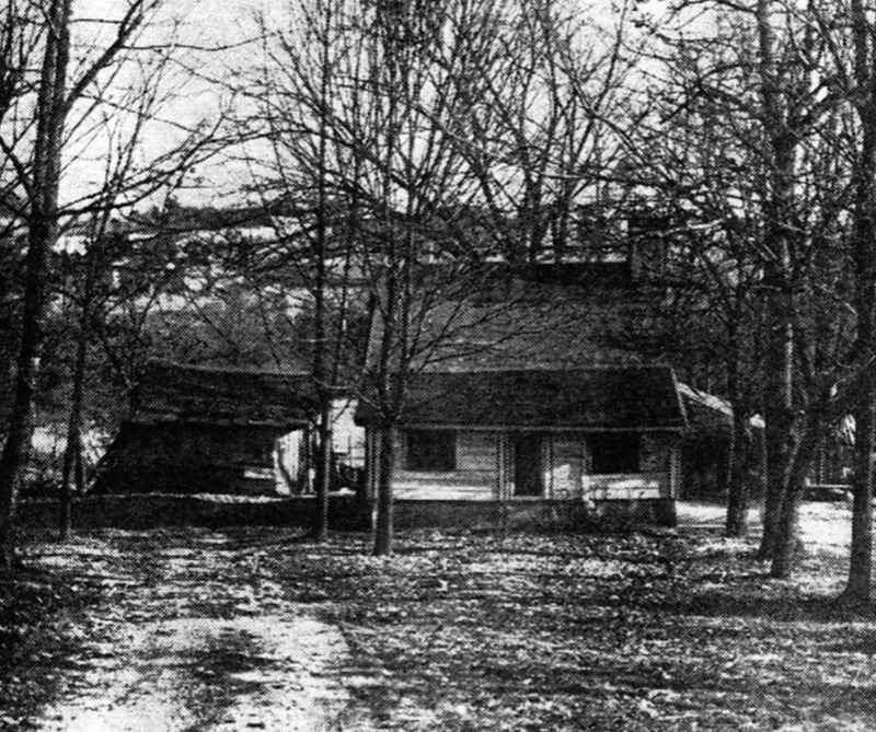 Unidentified newspaper photograph of the tarpaper-covered log house of Frederick Foote, Sr.