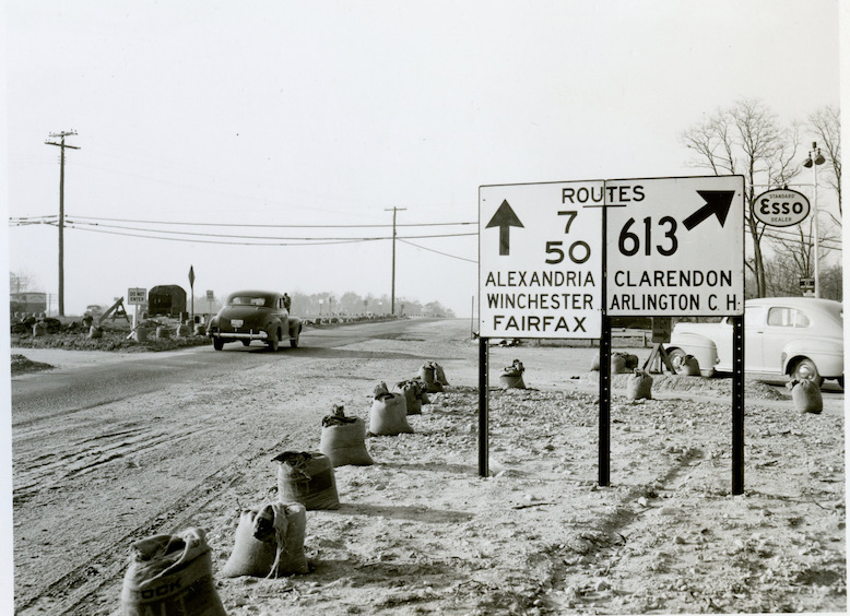 View of directional signs installed at channelized intersection at Seven Corners near Falls Church, Va in 1947.