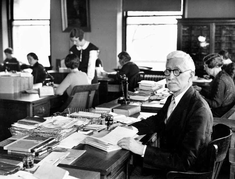 Black and white portrait of Walter A. Plecker sitting at a desk in an office setting, circa 1935.