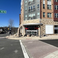 Picture of Tinner Hill Monument Arch in front of large apartment complex