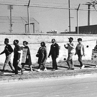 Photograph of Marching ACCESS Members along a road in Fairfax in 1966.