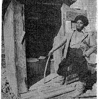 Community center employee Sonny Metcalf stands in front of LLV outhouse in 1980