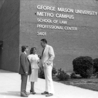 Photograph of John "Til" Hazel and students in front of a George Mason University building in 1982.