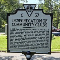 A close up of a historical marker entitled "Desegregation of Community Clubs" in Fairfax County.