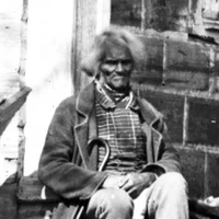 Photograph of West Ford sitting outside a building, circa 1860.