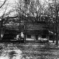 Unidentified newspaper photograph of the tarpaper-covered log house of Frederick Foote, Sr.