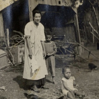 Photograph of Mary Ellen Henderson and her children: James Henderson (seated) and Edwin (“E.B.”) Henderson circa 1918.