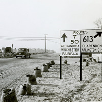 View of directional signs installed at channelized intersection at Seven Corners near Falls Church, Va in 1947.